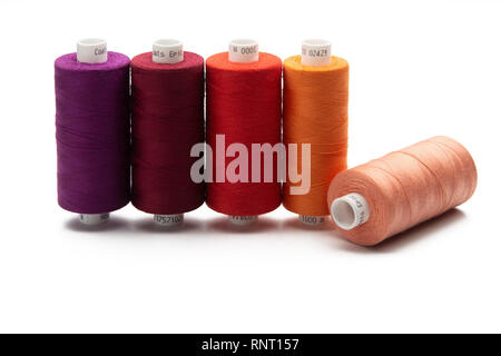 Set of color spool  sewing threads on isolated white background Stock Photo