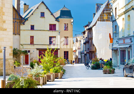 Amazing solitary city center of a small town Thouars, France. Many houses near a square, one bicycle and scooter standing near a cafe. Warm spring mor Stock Photo