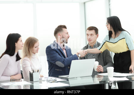 businesswoman shaking hands with the project Manager near the desktop Stock Photo