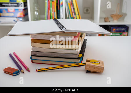 Stack of books and stationery on white background. Doing homework Stock Photo