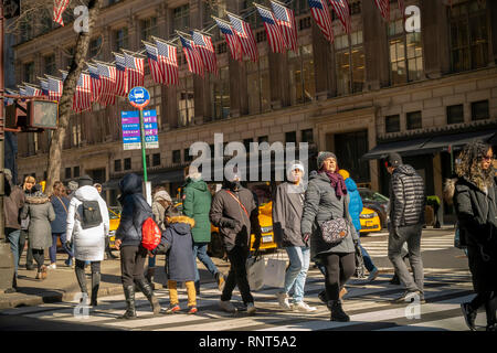 Pedestrians bundle up on a cold winter's day across from Saks Fifth Avenue  in Midtown Manhattan in New York on Saturday, February 9, 2019.(Â© Richard B. Levine) Stock Photo