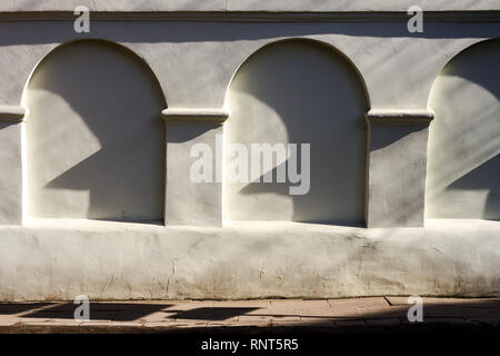 Old decorative wall with a shadow of itself. Stock Photo