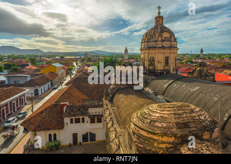 Urban cityscape of Granada City at sunset with the Merced church in the foreground in Spanish colonial style architecture, Nicaragua, Central America. Stock Photo