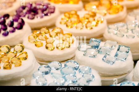 Colorful of different gemstones on a shopfront: amethyst, citrine, ruby and topaz. Stock Photo