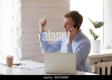 Cheerful business man talking on mobile phone Stock Photo
