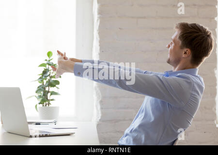 Worker doing effective stretching exercises during the working day Stock Photo