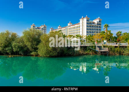Alanya, Turkey - October 05, 2018. Beautiful hotels of Turkey against the background of distant mountains and blue sky. Photos of coast from the sea.  Stock Photo
