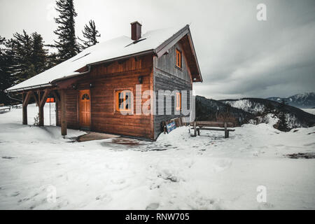 Snow covered house in the winter woods Stock Photo