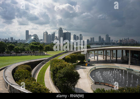 A thunderstorm approaching the city of Singapore seen from the Marina Barrage dam showing elegant concrete ramps and fountains. Stock Photo