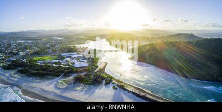 Aerial panorama of sunset with sun flare over Tallebudgera creek in Gold Coast, Queensland, Australia Stock Photo