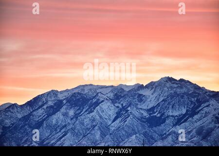 Sunrise of Winter panoramic, view of Snow capped Wasatch Front Rocky Mountains, Great Salt Lake Valley and Cloudscape from the Mountain view Corridor Stock Photo