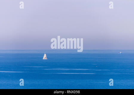 Boat racing across open ocean water. Boat speeding in the sea. Minimal nature photography. Beach view of maritime transportation. Minimal abstract nat Stock Photo