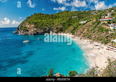 Harbor with sand beach, blue sea and mountain landscape in gustavia, st.barts. Summer vacation on tropical beach. Recreation, leisure and relax concept. Wanderlust and travel with adventure. Stock Photo
