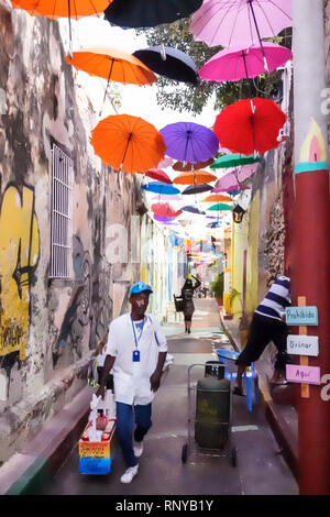 Cartagena Colombia,Center,centre,Getsemani,Callejon Angosto Calle 27 narrow street hanging colorful umbrellas installation,Hispanic Latin Latino ethni