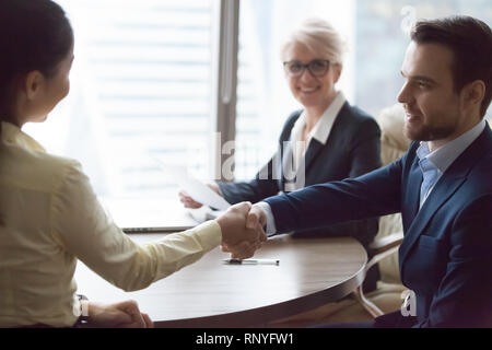 Happy hr manager hiring successful candidate at job interview Stock Photo