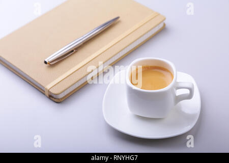 office table with notebook, computer keyboard,, cup of coffee, tablet pc. copy space. Stock Photo