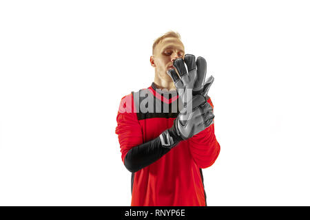 One male soccer player goalkeeper standing at studio. Silhouette isolated on white studio background Stock Photo