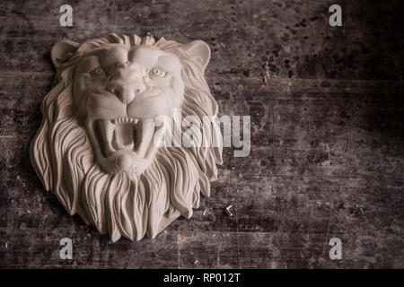 Creation of sculpture from plaster. Lion's head. Plaster workshop. Tooling. Stock Photo