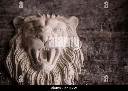 Creation of sculpture from plaster. Lion's head. Plaster workshop. Tooling. Stock Photo