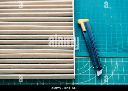 Wood and cutter set for making architecture models on working table. Top view Stock Photo