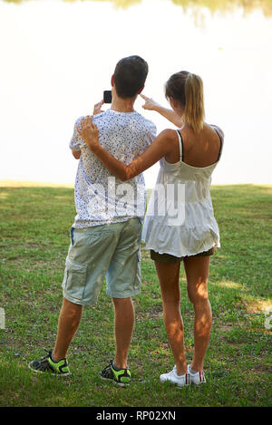 Young couple standing in park Stock Photo
