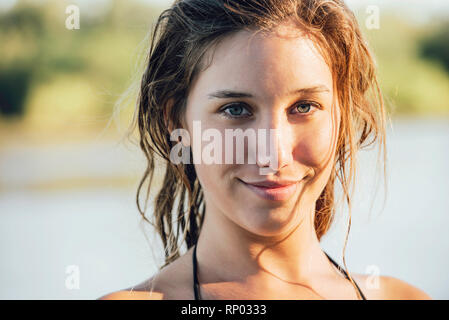 Portrait of young woman standing outdoors Stock Photo