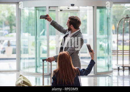 Business people taking selfie with smart phone Stock Photo