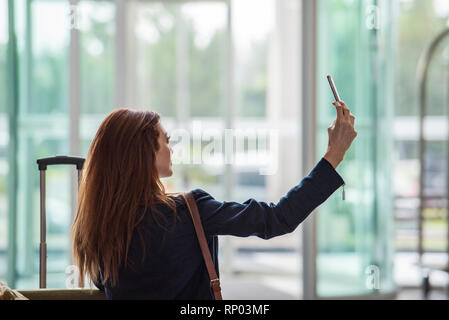 Businesswoman taking selfie with smart phone Stock Photo
