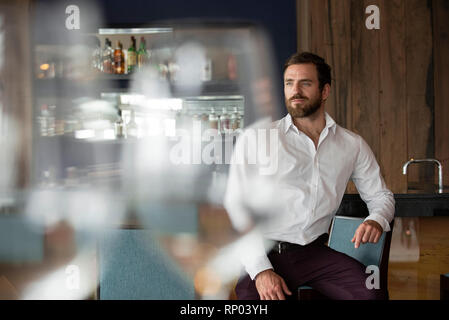 Mid adult man sitting in bar Stock Photo