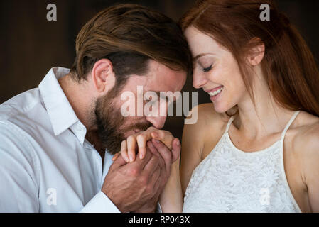 Close-up of man kissing his girlfriend's hand Stock Photo