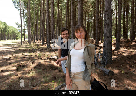 Young couple standing in forest Stock Photo