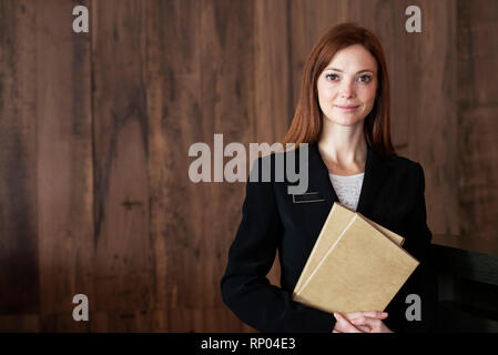 Female receptionist standing in hotel Stock Photo