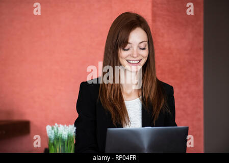 Businesswoman using laptop in hotel Stock Photo