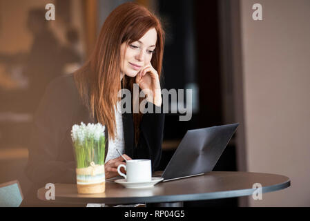 Businesswoman using laptop in hotel Stock Photo