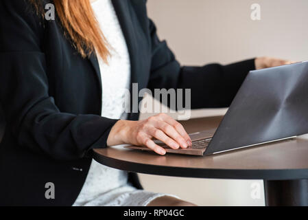 Businesswoman using laptop in hotel Stock Photo