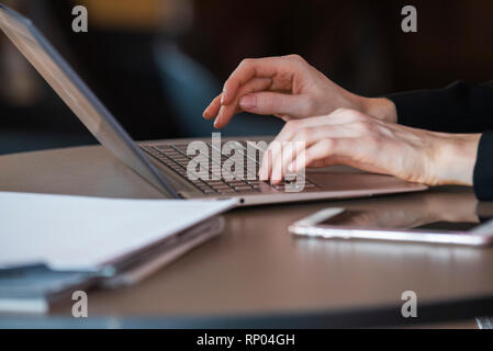 Businesswoman using laptop in hotel Stock Photo