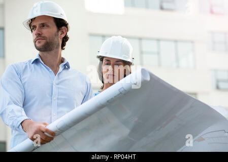 Architects reviewing blueprint Stock Photo