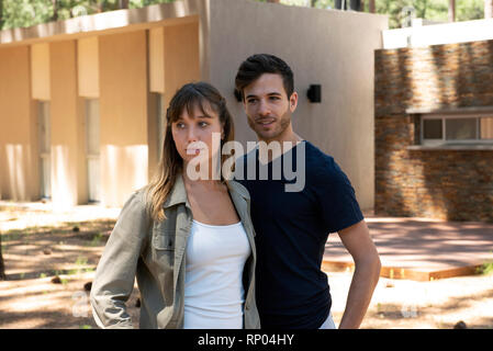 Thoughtful young couple standing outdoors Stock Photo