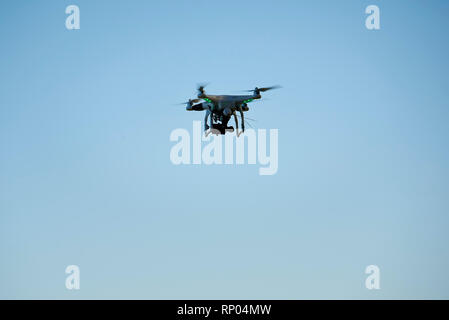 Drone flying against blue sky Stock Photo