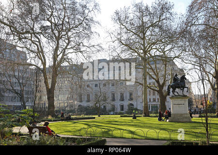 Sunny, winter day in St James's Square, London. Shows georgian buildings and William III statue. Stock Photo