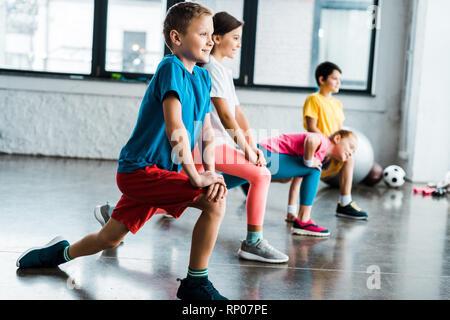 Kids warming up before training in gym Stock Photo