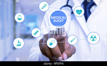 Index finger of indian man touching close-up medical audit button on transparent screen with symbol network and blue background Stock Photo