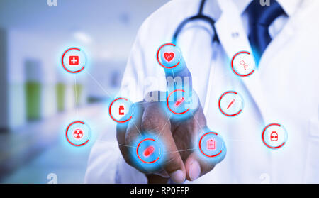 Indian cardiologist using index finger for choosing heart symbol on futuristic display as medical concept close-up Stock Photo