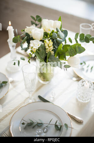 Beautiful festive table setting with elegant white flowers and cutlery, dinner table decoration closeup Stock Photo
