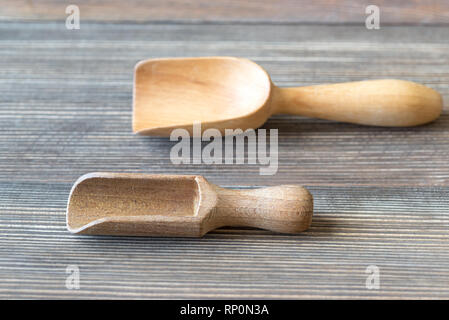 Two empty transfer scoops on the wooden table Stock Photo