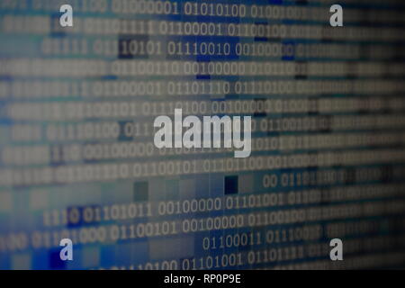 cold blue white binary winter. lines of binary codes moving from right to left on digital block shape pixels displayed on computer monitor. Stock Photo