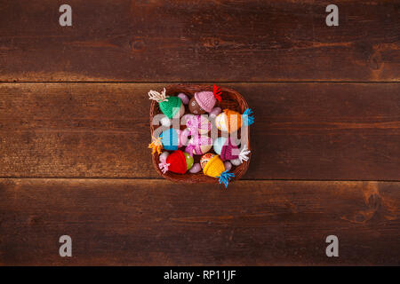 Easter basket filled with eggs on a vintage wooden background Stock Photo