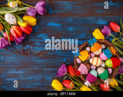Easter holiday postcard with empty space for your text and fresh tulip flowers on blue painted wooden planks Stock Photo
