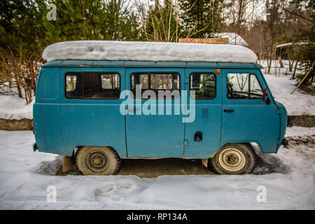 A UAZ-452 or ´Bread Loaf´ from the Soviet era vehicle manufacturing sits in snow in a small Russian village Stock Photo