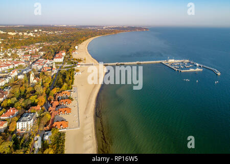 Poland, Sopot resort. Wooden pier (molo) with marina, yachts, sailboats, beach, old lighthouse, church, vacation infrastructure, hotels, park and prom